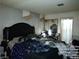 View of the bedroom with a bed with a decorative headboard and sliding mirror closet doors at 421 Miller Ave, North Las Vegas, NV 89030