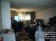 View of the bedroom with a television on a dresser and curtains in the window at 421 Miller Ave, North Las Vegas, NV 89030