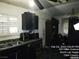 Functional kitchen featuring classic dark cabinetry, a stainless steel sink, and ample countertop space at 421 Miller Ave, North Las Vegas, NV 89030