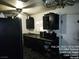 A practical kitchen showcases dark cabinetry with countertops and a stainless steel sink at 421 Miller Ave, North Las Vegas, NV 89030