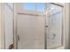 Bright bathroom features a tiled shower with glass doors at 4450 Zev Ct, Las Vegas, NV 89121