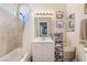 Bright bathroom with tile shower, white sink and vanity, and decorative mirror at 4450 Zev Ct, Las Vegas, NV 89121