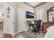 Charming bedroom area with desk, shutters, and television at 4450 Zev Ct, Las Vegas, NV 89121
