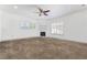 Bedroom featuring a fireplace, plush carpet, and shuttered windows for ample natural light at 4450 Zev Ct, Las Vegas, NV 89121