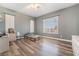 Bedroom featuring wood-look flooring, bright windows, and a neutral color scheme at 4450 Zev Ct, Las Vegas, NV 89121