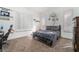 Bedroom featuring a neutral palette, plush carpeting, bright windows, and unique wall decor at 4450 Zev Ct, Las Vegas, NV 89121