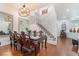 Dining area with stylish lighting, staircase, dark wood table set, and hardwood floors at 4450 Zev Ct, Las Vegas, NV 89121