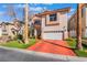 Charming two-story home featuring a well-maintained lawn and a red driveway at 4450 Zev Ct, Las Vegas, NV 89121