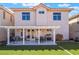 Beautiful two-story home featuring an artificial lawn and covered patio with outdoor seating at 4450 Zev Ct, Las Vegas, NV 89121