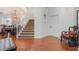 Foyer view showcases the staircase, hardwood floors, and decorative chair at 4450 Zev Ct, Las Vegas, NV 89121