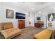 Cozy living room with comfortable seating, television, and large mirror at 4450 Zev Ct, Las Vegas, NV 89121