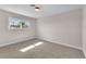 Simple bedroom featuring neutral carpet, window view, and lots of sunlight at 4571 Mcmillan Rd, Las Vegas, NV 89121