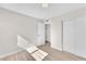 A minimalist bedroom with neutral walls, tile floors, closet and a bright window at 4571 Mcmillan Rd, Las Vegas, NV 89121