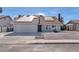 Charming single-story home showcasing solar panels, a two car garage, and low maintenance desert landscaping at 4571 Mcmillan Rd, Las Vegas, NV 89121