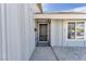 Inviting gated front door entrance with desert landscaping, window views, and gray siding at 4571 Mcmillan Rd, Las Vegas, NV 89121