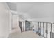 Hallway with carpet, neutral color palette and metal handrail overlooking the living room at 4571 Mcmillan Rd, Las Vegas, NV 89121