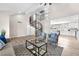 Spacious living room with spiral staircase leading to an upper level, gray furniture, and open layout at 4571 Mcmillan Rd, Las Vegas, NV 89121