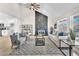 Bright living room featuring vaulted ceilings, stone fireplace, and stylish contemporary furnishings at 4571 Mcmillan Rd, Las Vegas, NV 89121