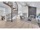 Open-concept living room with spiral staircase, stone fireplace, and modern furnishings at 4571 Mcmillan Rd, Las Vegas, NV 89121