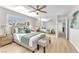 Bright main bedroom featuring a bed, ceiling fan, mirrored closet and a bright window at 4571 Mcmillan Rd, Las Vegas, NV 89121