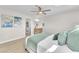 Bright main bedroom featuring a bed, ceiling fan, side tables and ensuite bathroom at 4571 Mcmillan Rd, Las Vegas, NV 89121
