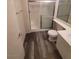 A clean bathroom featuring a glass shower, modern vanity, and wood-look flooring at 5000 Red Rock St # 202, Las Vegas, NV 89118
