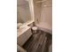 Bright bathroom featuring a tub, shower, modern vanity, and wood-look flooring at 5000 Red Rock St # 202, Las Vegas, NV 89118