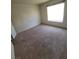 Bright bedroom with a large window, carpet flooring, and light neutral decor at 5000 Red Rock St # 202, Las Vegas, NV 89118