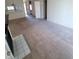 Spacious carpeted living room with vaulted ceiling, featuring bar seating and neutral decor at 5000 Red Rock St # 202, Las Vegas, NV 89118
