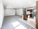 Open-concept living room and kitchen with island, pendant lights, and gray carpet at 5721 Coral Sun St, North Las Vegas, NV 89031