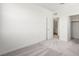 A bright bedroom features neutral carpet, white walls and trim and access to a large closet and ensuite bathroom at 637 N Water St, Henderson, NV 89015