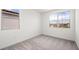 Bedroom with neutral carpeting and two windows offering neighborhood views at 637 N Water St, Henderson, NV 89015