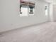 Bedroom with neutral carpet, white walls, and window overlooking the backyard at 637 N Water St, Henderson, NV 89015