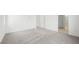 A spacious primary bedroom features neutral carpet, white walls and trim and access to other rooms at 637 N Water St, Henderson, NV 89015