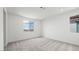 A bedroom features neutral carpet, white walls and trim and bright double windows with a view at 637 N Water St, Henderson, NV 89015