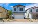 Charming two-story home featuring a two-car garage and desert landscaping at 637 N Water St, Henderson, NV 89015