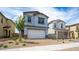 Charming two-story home featuring a two-car garage and desert landscaping at 637 N Water St, Henderson, NV 89015