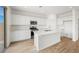Modern kitchen featuring white cabinets, quartz countertops, and stainless steel appliances at 637 N Water St, Henderson, NV 89015