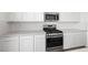 Close up of modern kitchen appliances, quartz countertops and stylish tile backsplash at 637 N Water St, Henderson, NV 89015