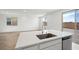 Kitchen island featuring stainless steel dishwasher and modern faucet at 637 N Water St, Henderson, NV 89015