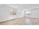 Bright and spacious living room with wood-look flooring and multiple windows at 637 N Water St, Henderson, NV 89015
