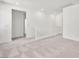 Neutral carpeted loft area with white railing, bright natural light, and open space at 637 N Water St, Henderson, NV 89015
