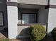 Exterior view of apartment patio with sliding glass door, exterior door, and green bushes at 7255 W Sunset Rd # 1171, Las Vegas, NV 89113