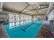 Bright indoor pool with lap lanes and plenty of natural light coming in through large windows at 794 Sunny Sagebrush St, Henderson, NV 89011