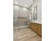 Luxurious bathroom with glass shower and a vanity featuring wood cabinetry and modern fixtures at 800 Jody Brook Ct, Las Vegas, NV 89145