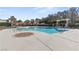 Community pool with lounge chairs and umbrellas at 800 Jody Brook Ct, Las Vegas, NV 89145