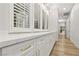 Bright hallway with custom built-ins, white cabinets, modern hardware, and light wood flooring throughout at 800 Jody Brook Ct, Las Vegas, NV 89145