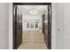 View through the double-door entry reveals a living room with wood flooring and modern chandeliers at 800 Jody Brook Ct, Las Vegas, NV 89145