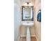 Elegant powder room with a pedestal sink and decorative mirror at 865 Eureka Falls Ct, Henderson, NV 89052