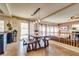 This dining area features sliding door access, a large wooden table set and natural light in the dining space at 865 Eureka Falls Ct, Henderson, NV 89052